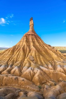 Majestic castildetierra rock formation rises against a vibrant blue sky in the bardenas reales