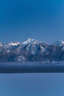 Shortly after sunset, twilight at Lake Hopfensee in the Allgäu in Bavaria in a winter landscape,