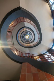 Dizzying view through a spiral staircase with red and black elements, SPRINKENHOF, Hamburg, Germany