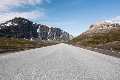 Experience the breathtaking scenery of Norway with a road trip through serene mountains Perfect for