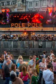 Spectators on grandstand at the Graslei watching Pole Pole podium during Gentse Feesten, Ghent city