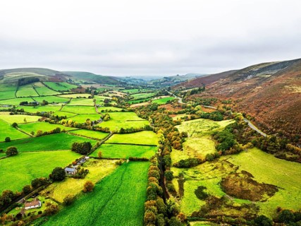 Autumn colours of Farms over River Wye and Road A470 from a drone, Llanidloes, Powys,