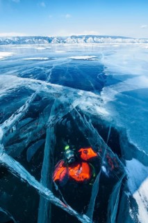 Scuba diver under ice, Lake Baikal, Pribaikalsky National Park, Irkutsk Province, Siberia, Russia