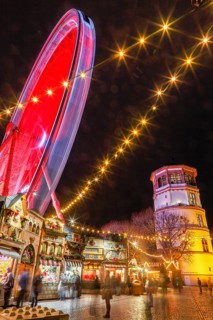 Rhine promenade with Castle Tower and illuminated Ferris wheel at dusk, Dusseldorf, North