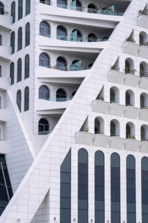 A striking modern building features geometric patterns and arches, located in Georgia. The white