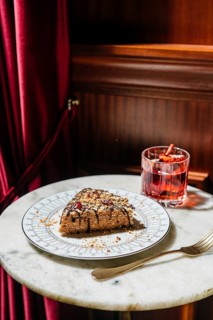 A delectable waffle cake layered with creamy truffle condensed milk, topped with chocolate drizzle,