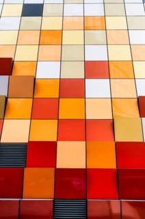 Close-up view of a vibrant and multi-colored tiled facade of a building in Hong Kong. The image