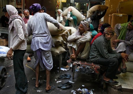New Delhi, India, 14.01.10 - Workers stacking bags at market, India