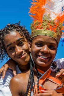 Colourful costumed, pretty, young woman with boyfriend. Carnival. Mindelo. Cabo Verde. Africa