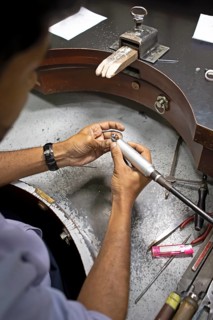 Gemstone cutter cutting a sapphire ring, gemstone cutting workshop in Kandy, Central Province, Sri