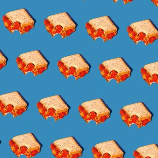 A creative pattern of sandwiches with vibrant red floral fillings set against a bright blue
