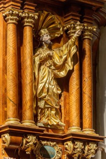 Carved wooden figure of St Augustine on the pulpit of the parish church of the Assumption of the