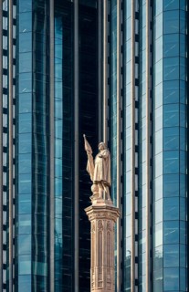 A striking display of architectural contrast in Colon City, Panama, showing a historic statue