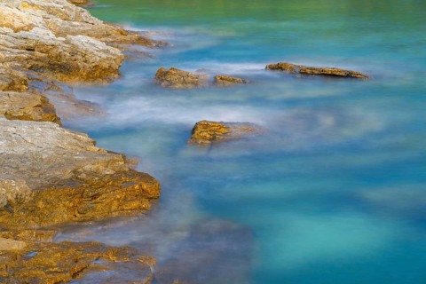 Crystal clear and turquoise water on the beach of Ustrine Bay on a sunny day on the island of Cres,