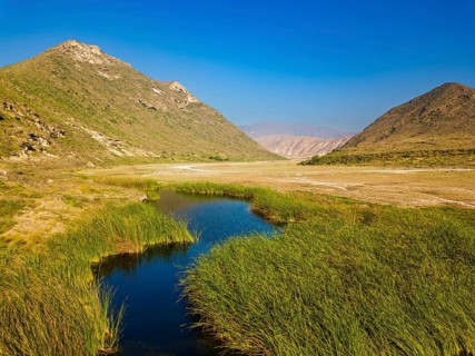 Landscape in Oman, mountains, Wadi Ashawq, road, reeds, waters Salalah, Al Mughsyal / Wadi Ashawq,