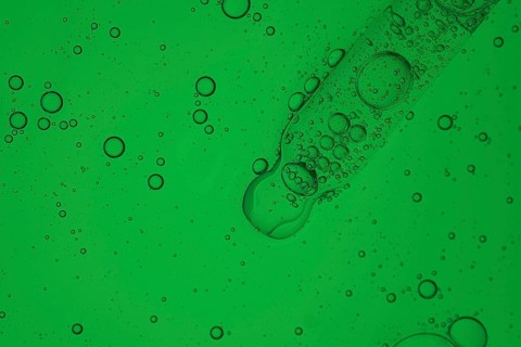 A detailed image showcasing a vibrant aloe vera liquid for a serum cosmetic, creating a mesmerizing
