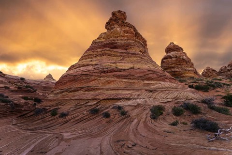 Vibrant sunset illuminates the swirling sandstone formations of Coyote Buttes in the Paria