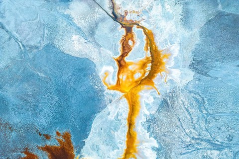 Aerial photo capturing a vibrant, abstract landscape where natural textures and colors mix