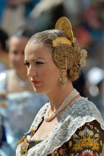 Fallas festival, woman in a traditional costume during the parade in the Plaza de la Virgen de los