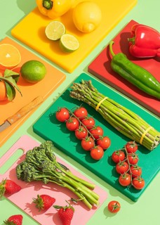 A vibrant display of assorted fresh fruits and vegetables, including tomatoes, asparagus, and