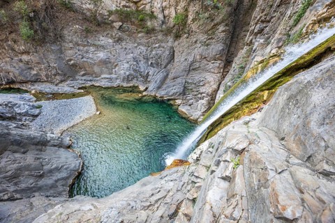 A breathtaking view of a canyon with crystal-clear waters, perfect for adventure seekers enjoying