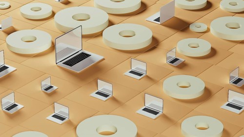This setting displays numerous laptops arranged among circular tiles on a smooth surface,