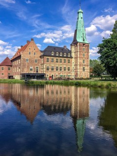View over moat on moated castle Raesfeld, below reflection on water surface, Hohe Mark nature park