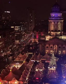 Aerial view of an illuminated Christmas market at Gendarmenmarkt at night with distinctive