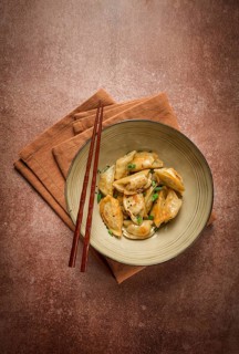 Japanese fried gyoza dumplings, with pork, sesame seeds, green onions