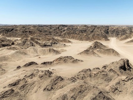 Aerial view, dry barren mountains in Moon Valley, rocky landscape ridged by erosion, Namib-Naukluft
