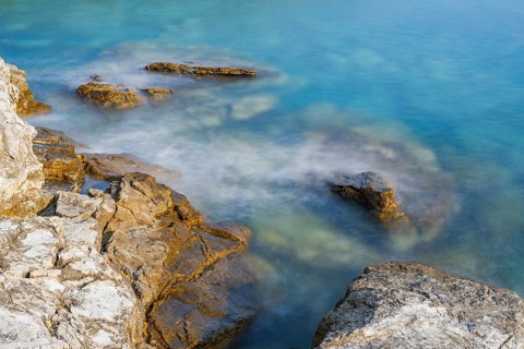 Crystal clear and turquoise water on the beach of Ustrine Bay on a sunny day on the island of Cres,