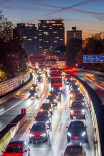 Evening traffic, partly with traffic jams, slow-moving traffic on the A40 motorway, Essen skyline,