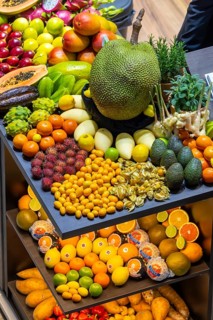 Exotic fruits, lychee, jackfruit, dragon fruit, mango and citrus fruits presented on a table,