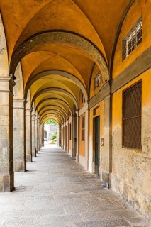 Arched arcades in Via Elisa, historic city centre, Lucca, Tuscany, Italy