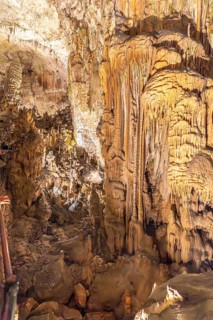Tourists marvel at the stunning stalactites and stalagmites formations inside postojna cave, a
