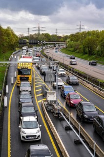 Weighing and barrier system on the A42 motorway, in front of the dilapidated motorway bridge over