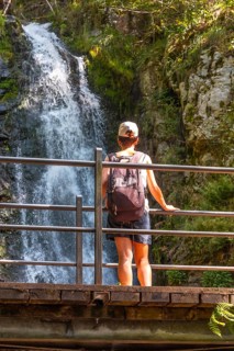 A woman at the top of the Todtnau waterfall in the Black Forest in Germany