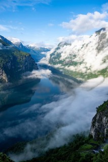Atmospheric clouds over the fjord in the morning light, view of Geirangerfjord, at Ørnesvingen