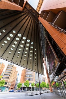 Tall, modern buildings with glass facades and geometric shapes that offer a broad urban