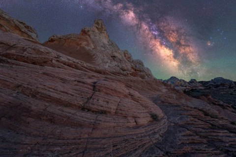 Stunning nightscape of the Milky Way over the unique rock formations in White Pocket, Arizona, USA.