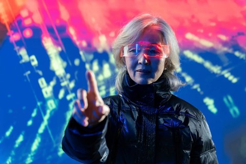 An elderly Asian woman in futuristic glasses interacts with digital elements in the metaverse,