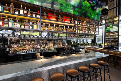 Fort Lauderdale restaurant bar with a variety of wine and liquor bottles and glasses on the shelves