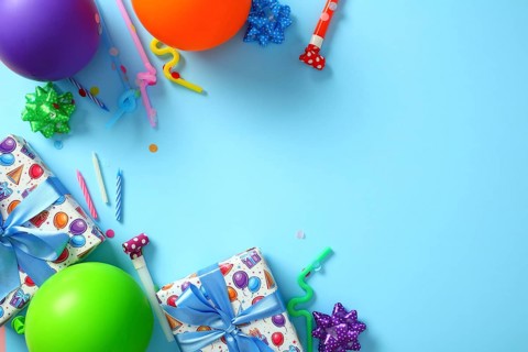 Bright birthday party decorations on blue background. Happy Birthday greeting card template. Flat
