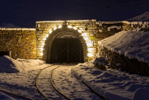 Illuminated mouth hole from Markus-Röhling-Stolln visitor mine in the snow, historical origin to
