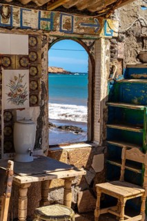 Interior of an old, charming, colorful, abandoned beach house with ocean view in ojos de garza