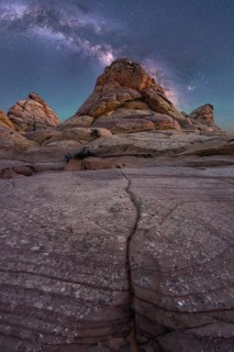 Captivating image of rugged desert rock formations beneath a vibrant Milky Way in Coyote Buttes,