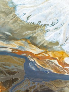 Top view aerial shot capturing the enticing swirls and organic patterns formed by natural elements.