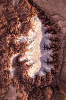 This stunning aerial image captures the intricate, textured sandstone formations of Goblin Valley
