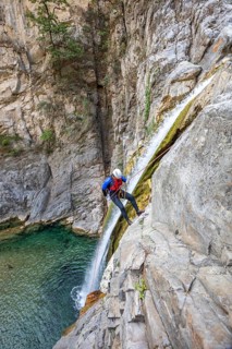 Enthusiastic canyoneer participates in exciting canyoning and rappelling activities in Matacanes,