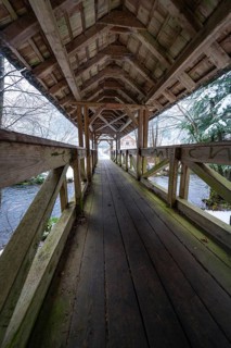 Long walkway of a wooden bridge over a wintry river course, Kälberbrücke, Enzklösterle, Calw
